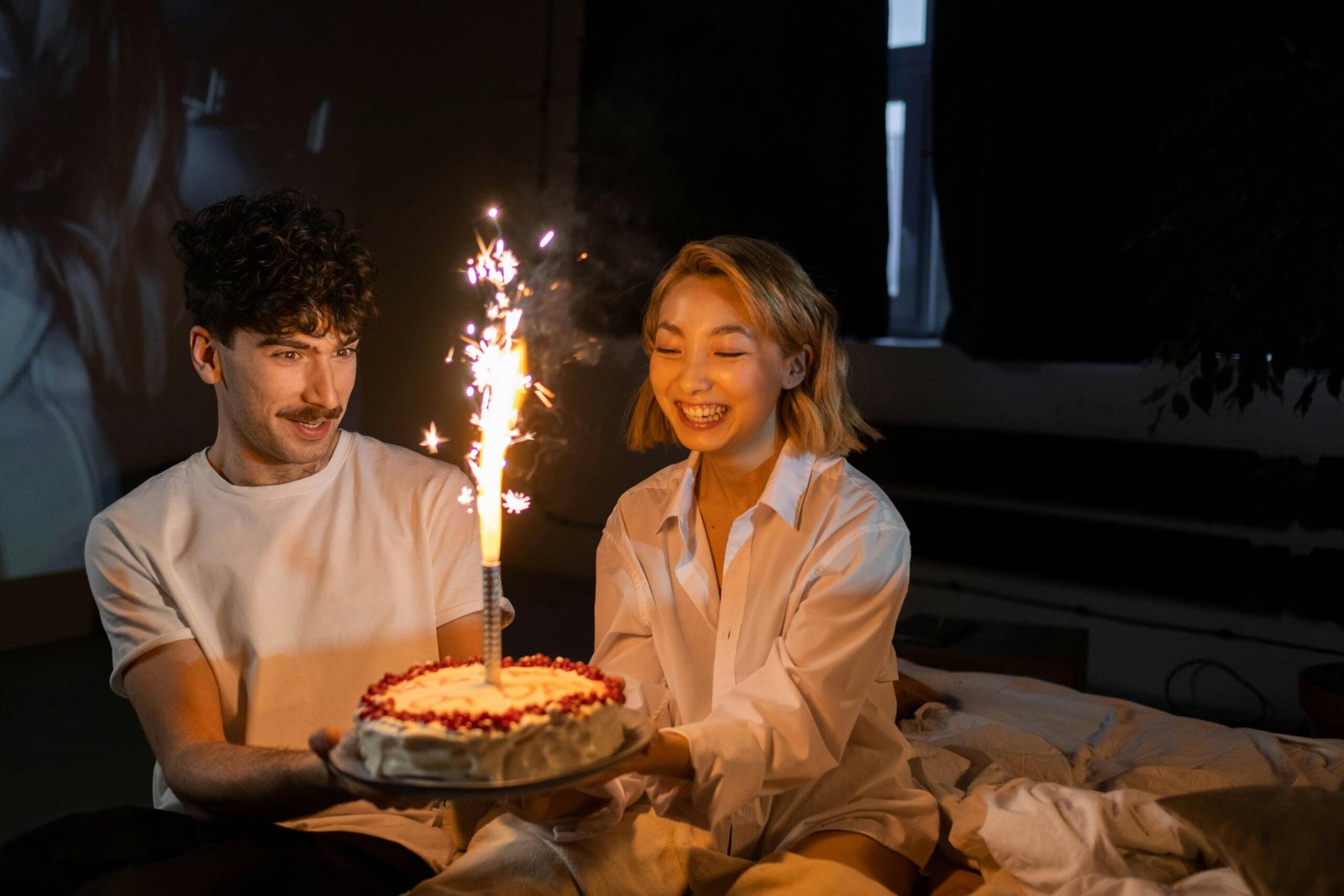 A couple celebrating with a cake in hand